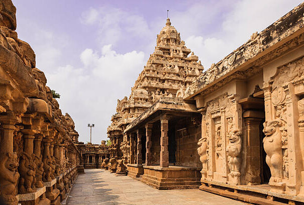 Built on the banks of the Vedavathi River, the 1300 year old Kailasanathar Temple is the oldest structure in in the Tamil Nadu city of Kanchipuram in South India.  Built by the Pallava King Rajasimha also known as Narasimhavarman II, in the Dravidian style of architecture, Carved and sculpted almost completely out of sandstone, it was built between 685 and 705 AD; it is dedicated to the god Shiva. Photo shot in the afternoon sunlight shows the circumambulatory passage of the western side; on the left is the inner side of the outer wall as well. Each of the sections houses a shrine - 58 in total. Converging lines make for an interesting photograph. Horizontal format; no people. Copy Space.
